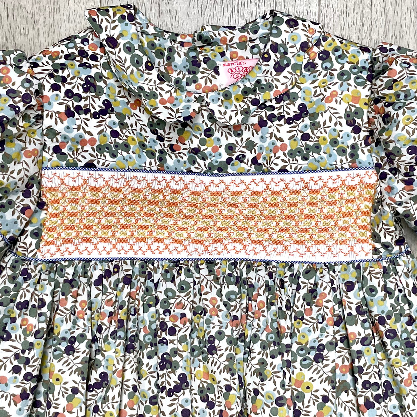 Handmade smocked floral dress in green, gray blue and coral with coral  smocking
